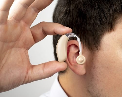 side-view-man-wearing-hearing-aids-min